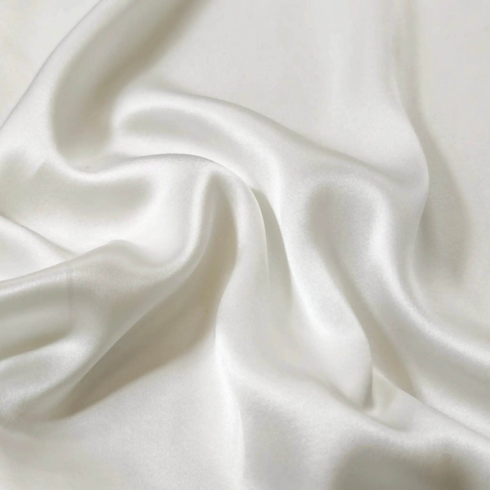 Ivory White mulberry silk fabric close-up — smooth 22 momme silk with natural sheen and soft texture.