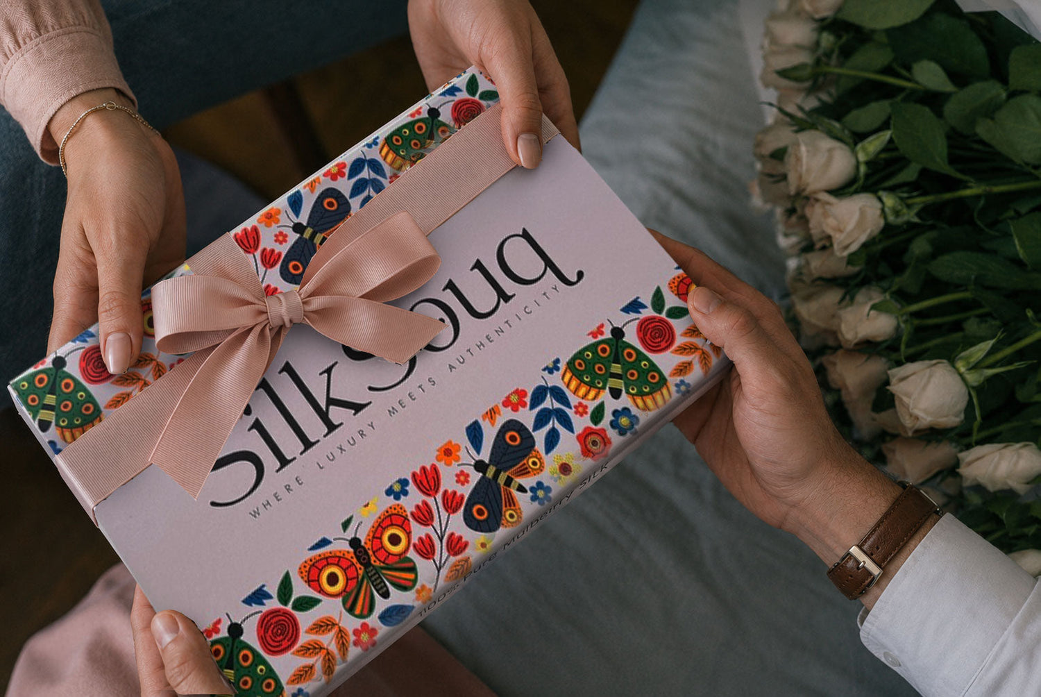 two hands passing a silk souq gift box — meaningful gift ideas for someone you love